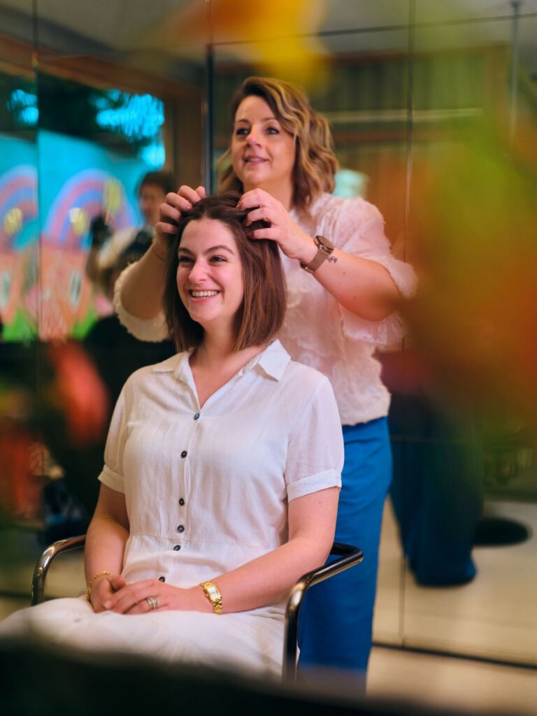 Kapster aan het werk in een kleurrijk salon